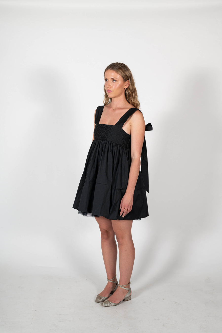 The Dolly Mini Dress in black taffeta with bow straps and quilted bodice by Australian brand House of Campbell.