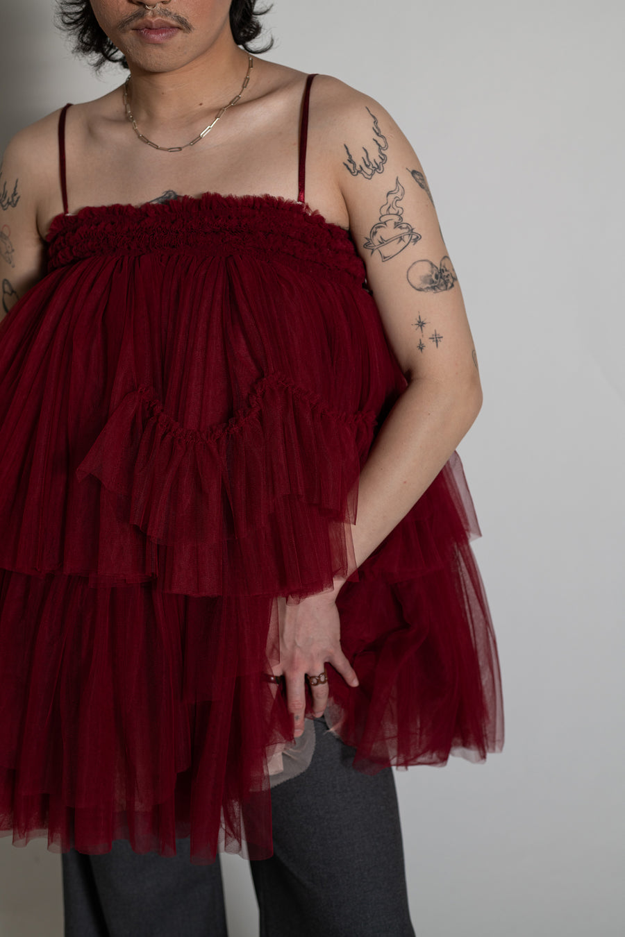 Jake wears the Maurice Tulle Mini Dress in deep red by House of Campbell.