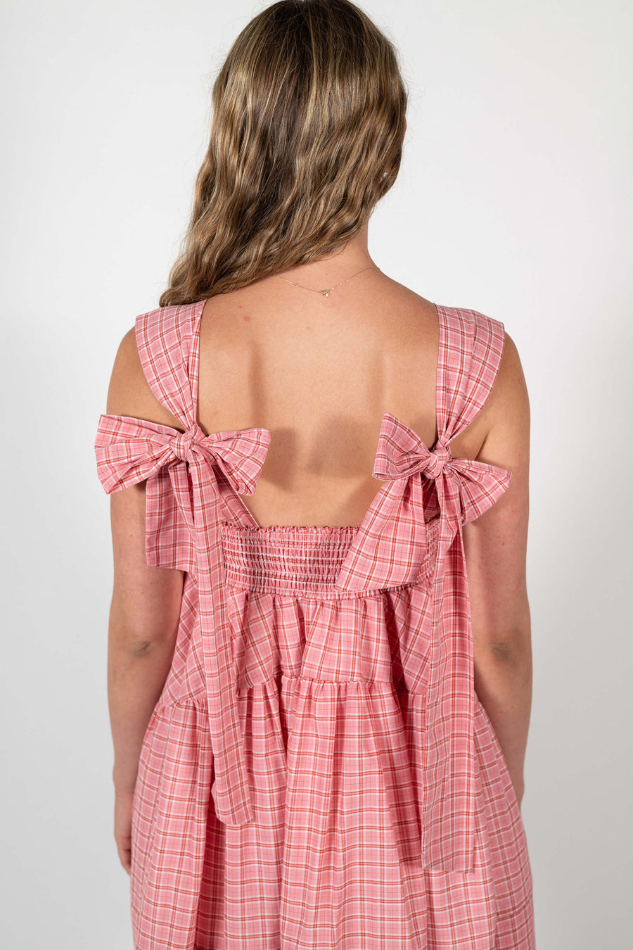 Back bow details of the Mirabel Dress in rose pink plaid. by House of Campbell